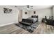 Bedroom features gray wood flooring, ceiling fan, and a gray accent rug at 10701 Morning Dew Way, Tampa, FL 33647