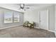 Bedroom features two green chairs with natural light from two large windows at 10701 Morning Dew Way, Tampa, FL 33647