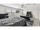 Bedroom featuring modern furniture, many windows, and hardwood floors at 10701 Morning Dew Way, Tampa, FL 33647