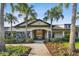 A well-maintained community clubhouse with stone accents and lush landscaping at 10701 Morning Dew Way, Tampa, FL 33647