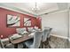 Dining room featuring a dark wood table, six chairs, and modern artwork at 10701 Morning Dew Way, Tampa, FL 33647
