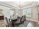 Bright dining area with wood floors, a tray ceiling, and view to entry at 10701 Morning Dew Way, Tampa, FL 33647