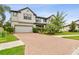 Charming two-story home with a brick driveway and well-maintained landscaping at 10701 Morning Dew Way, Tampa, FL 33647