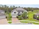 Two-story home with meticulous landscaping, paved driveway, and neutral paint at 10701 Morning Dew Way, Tampa, FL 33647