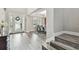 Inviting foyer featuring hardwood floors, a decorative entry door, and a view of the dining area at 10701 Morning Dew Way, Tampa, FL 33647