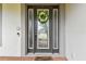 Elegant front entryway with a decorative wreath and patterned glass at 10701 Morning Dew Way, Tampa, FL 33647