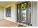 Elegant front entrance with a decorative wreath and a welcoming doormat at 10701 Morning Dew Way, Tampa, FL 33647