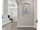 Hallway displaying neutral paint, arched doorway, and a framed sailboat picture at 10701 Morning Dew Way, Tampa, FL 33647