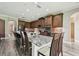 Large kitchen island with granite countertop, bar seating, and stainless steel appliances at 10701 Morning Dew Way, Tampa, FL 33647