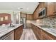 Spacious kitchen features granite counters, stainless appliances, and mosaic tile backsplash at 10701 Morning Dew Way, Tampa, FL 33647