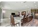 Open-concept kitchen and dining area with granite countertops and modern appliances at 10701 Morning Dew Way, Tampa, FL 33647