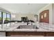 Kitchen island features granite counters, stainless steel sink and pendant lighting at 10701 Morning Dew Way, Tampa, FL 33647