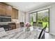 Eat in kitchen area featuring granite countertops and views of the lush outdoor space at 10701 Morning Dew Way, Tampa, FL 33647