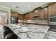 Modern kitchen with granite countertops, stainless steel appliances, and ample counter space at 10701 Morning Dew Way, Tampa, FL 33647