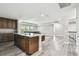 Open-concept kitchen features an island with seating and countertop, and hardwood floors at 10701 Morning Dew Way, Tampa, FL 33647