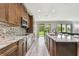 Stylish kitchen with granite countertops, stainless steel appliances, and open floor plan at 10701 Morning Dew Way, Tampa, FL 33647