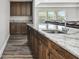 Kitchen view showing island with counterspace, seating and cabinets at 10701 Morning Dew Way, Tampa, FL 33647