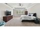 Spacious main bedroom with a tray ceiling, carpet, and large window at 10701 Morning Dew Way, Tampa, FL 33647