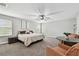 Spacious main bedroom with a ceiling fan, carpet floors, furniture, and windows at 10701 Morning Dew Way, Tampa, FL 33647