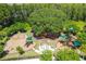 Aerial view of a community playground with multiple play areas and green canopies at 10701 Morning Dew Way, Tampa, FL 33647