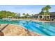 A long pool, with a clubhouse in the background, reflecting the blue sky at 10701 Morning Dew Way, Tampa, FL 33647