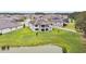 Back of a well-maintained home featuring a large backyard and second-story balcony at 10701 Morning Dew Way, Tampa, FL 33647
