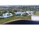 Gorgeous aerial view of community pool, clubhouse, and a waterfront view of the lake at 12215 Blue Pacific Dr, Riverview, FL 33579