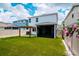 Beautiful backyard with green turf, wooden pergola, and a screened-in porch at 12215 Blue Pacific Dr, Riverview, FL 33579