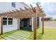 Backyard featuring a wooden pergola and artificial turf at 12215 Blue Pacific Dr, Riverview, FL 33579