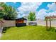 Backyard featuring artificial turf, a custom bar, and a bench seating area at 12215 Blue Pacific Dr, Riverview, FL 33579