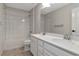 Bathroom features a double sink, tile floor, white cabinets and a shower over tub at 12215 Blue Pacific Dr, Riverview, FL 33579
