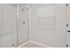 Bathroom features a tiled shower with glass door and bench at 12215 Blue Pacific Dr, Riverview, FL 33579
