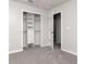 This bedroom features gray carpet and a closet with shelving installed at 12215 Blue Pacific Dr, Riverview, FL 33579
