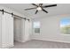 Bedroom showcases carpet, ceiling fan, and barn door closet at 12215 Blue Pacific Dr, Riverview, FL 33579