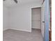 This bedroom features gray carpet and a walk-in closet with installed shelving at 12215 Blue Pacific Dr, Riverview, FL 33579
