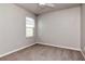 This bedroom features neutral walls, ceiling fan and natural light from the window at 12215 Blue Pacific Dr, Riverview, FL 33579