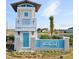 Lucaya Lake Club entrance featuring a blue and white coastal theme with lush landscaping at 12215 Blue Pacific Dr, Riverview, FL 33579