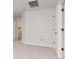 Upstairs hallway with gray walls, neutral carpet, white door and a laundry room in view at 12215 Blue Pacific Dr, Riverview, FL 33579