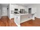 Open-concept kitchen boasts an island, stainless appliances, and white cabinets at 12215 Blue Pacific Dr, Riverview, FL 33579
