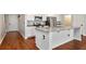 Modern kitchen features stainless appliances, granite countertops, white cabinets, and an island at 12215 Blue Pacific Dr, Riverview, FL 33579