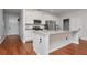 Modern kitchen features stainless appliances, granite countertops, white cabinets, and an island at 12215 Blue Pacific Dr, Riverview, FL 33579