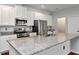 Bright kitchen with granite counters, stainless appliances, and white cabinets at 12215 Blue Pacific Dr, Riverview, FL 33579