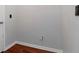 A laundry room with gray walls, white trim, and dark wood-look flooring at 12215 Blue Pacific Dr, Riverview, FL 33579