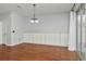 Open living room featuring hardwood floors, modern lighting, built-in cabinets, and sliding glass doors at 12215 Blue Pacific Dr, Riverview, FL 33579
