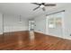 Bright living room with hardwood floors, modern lighting fixture, built-in cabinets, and sliding glass doors at 12215 Blue Pacific Dr, Riverview, FL 33579
