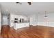 Open-concept living area with stylish lighting, modern kitchen, and wood-look floors at 12215 Blue Pacific Dr, Riverview, FL 33579