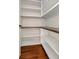 Walk-in pantry features white shelves, brick-style backsplash, and dark wood countertops at 12215 Blue Pacific Dr, Riverview, FL 33579