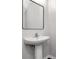 Stylish powder room featuring a pedestal sink with chrome faucet and minimalist mirror at 12215 Blue Pacific Dr, Riverview, FL 33579