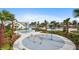 Fun-filled splash pad area with colorful features, surrounded by palm trees and lush landscaping at 12215 Blue Pacific Dr, Riverview, FL 33579
