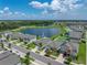 Aerial view shows the single-Gathering home's location near a scenic lake and green spaces in the community at 12931 Twin Bridges Dr, Riverview, FL 33579